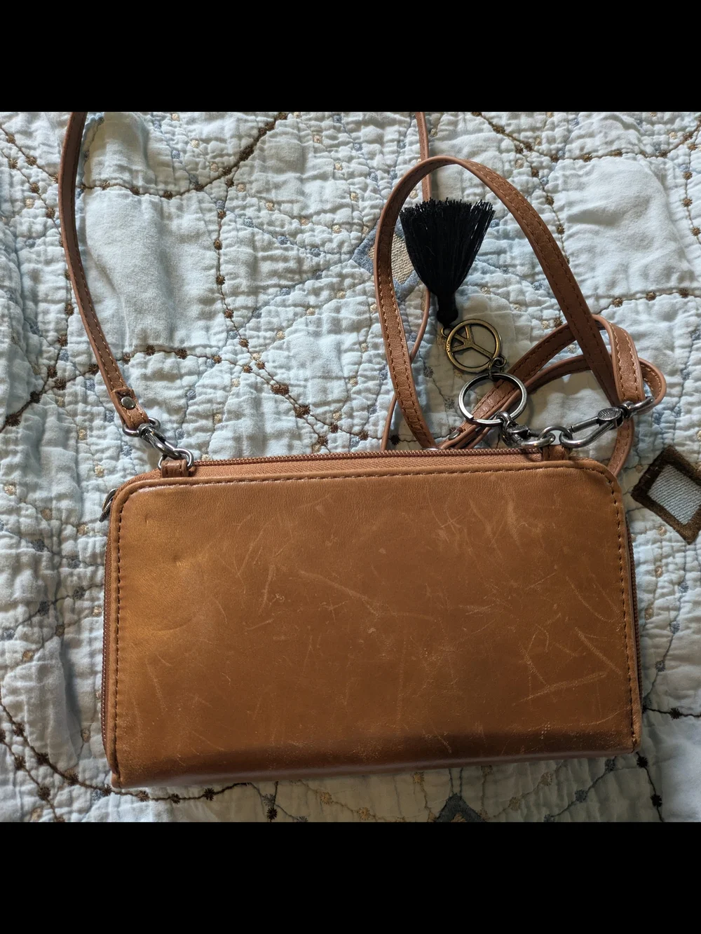 The Sak tan leatherette crossbody wristlet